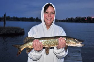 Photo of a woman with a northern pike.